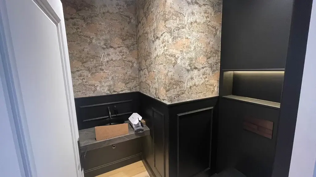 Bespoke cloakroom wall panelling with a fitted basin and recessed niche
