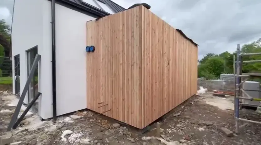 Residential extension with vertical timber cladding to one elevation