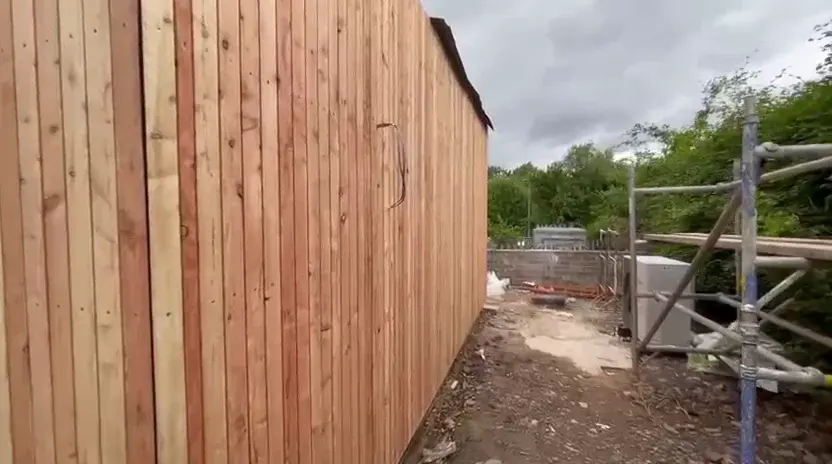 Vertical cladding boards being fitted to the extension