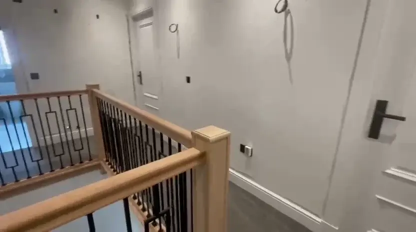 Staircase with timber handrail and metal balustrade