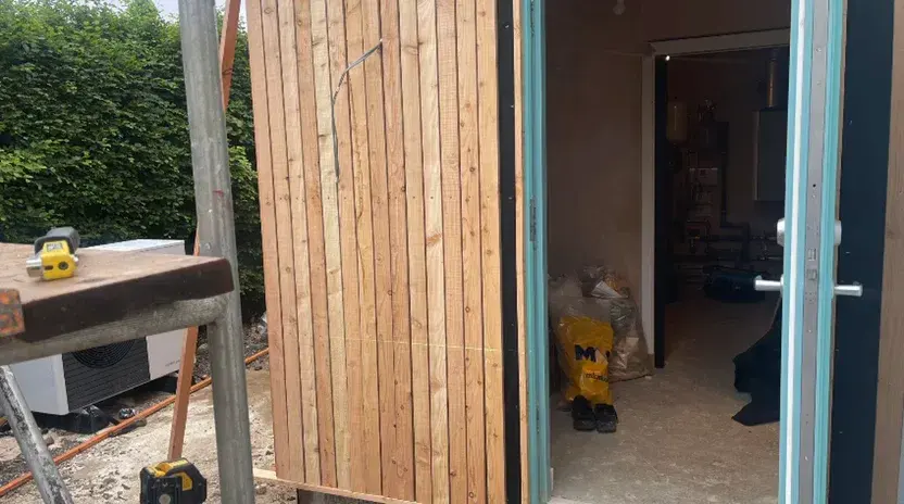Vertical cladding progressing across the extension elevation