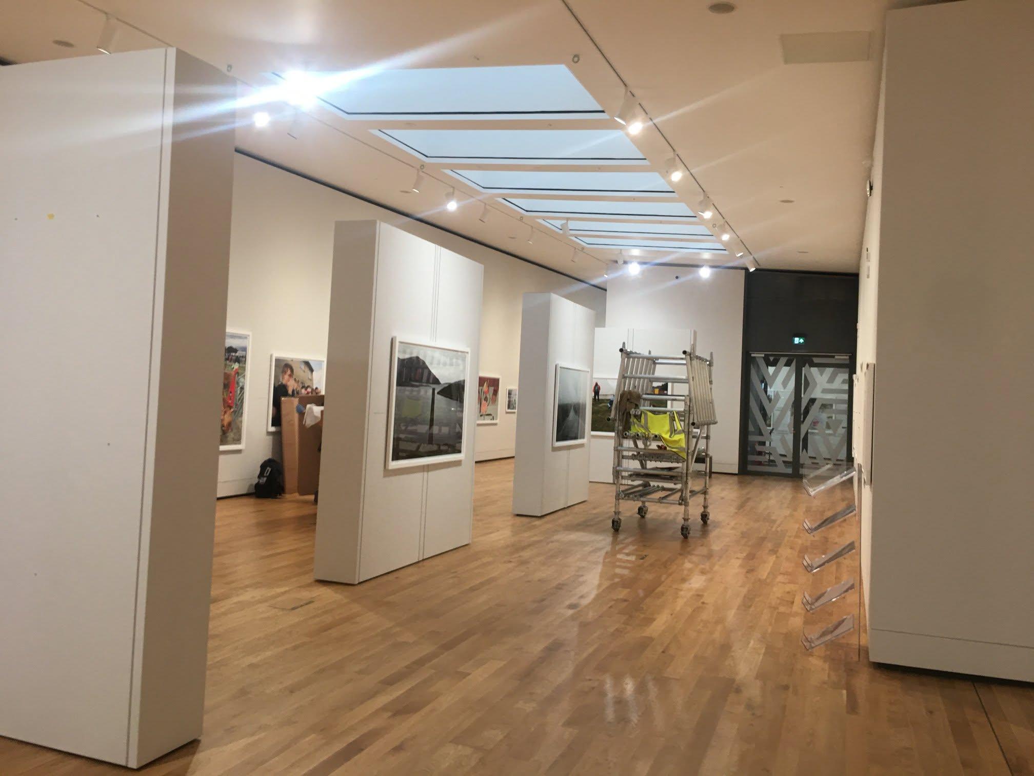 Commercial gallery interior fit-out with freestanding display walls and a timber floor