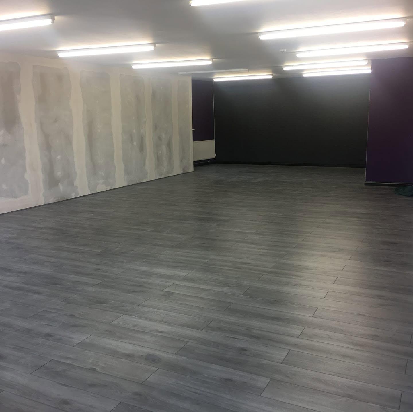 Grey vinyl flooring installation in a commercial interior