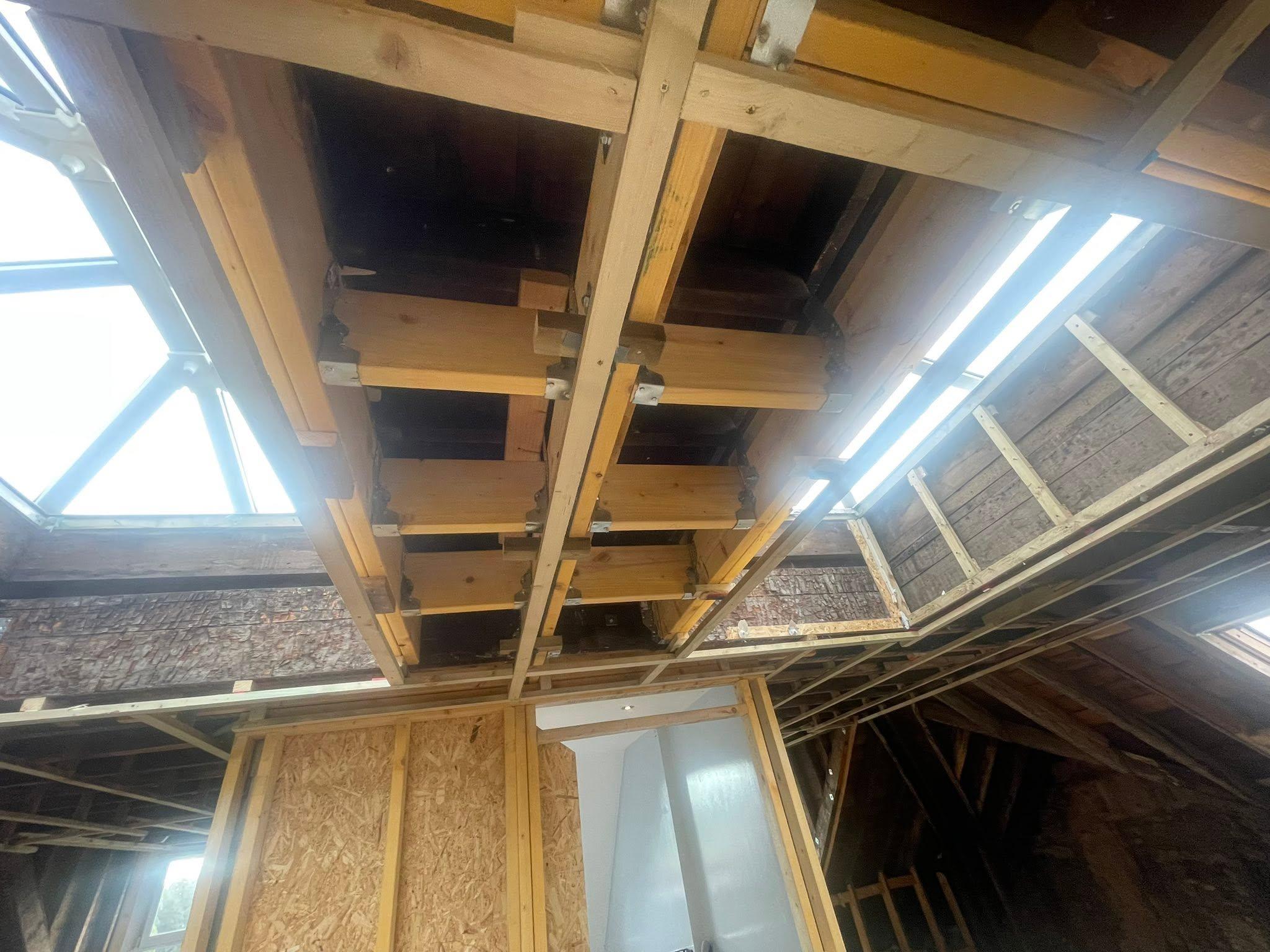 Timber structural frame and joists under a rooflight during a refurbishment